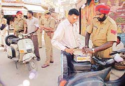 Police personnel check vehicles as part of stepped up security in Ludhiana on Wednesday