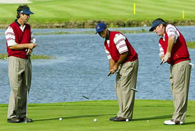 Paul Azinger and Mark Calcavecchia watch Tiger Woods of the US team putt on the ninth hole during the second practice round ahead of the 34th Ryder Cup at the Belfry in Warwickshire 
