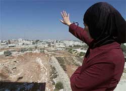 Palestinian Ohood Sawalmeh waves towards the compound of Palestinian President Yasser Arafat 