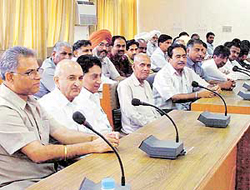 Commission agents being briefed by district administration officials on issues relating to the procurement of paddy in Ludhiana on Friday. 