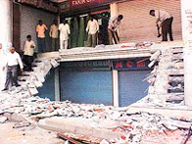 An MC demolition drive in progress on the Cemetery Road in Ludhiana on Friday.