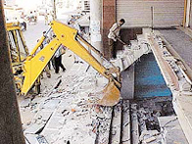 An MC demolition drive in progress on the Cemetery Road in Ludhiana on Friday.