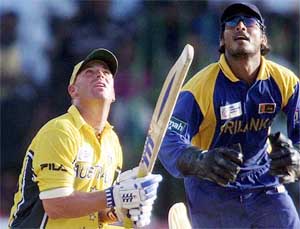 Australian batsman Shane Warne and Sri Lankan wicketkeeper Kumar Sangakkara look skywards