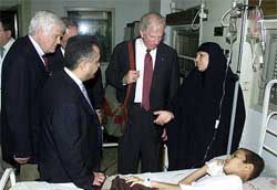Congressmen Jim Mcdermott and David E. Bonior listen to an Iraqi woman whose son is suffering from leukemia at Maunsour hospital in Baghdad