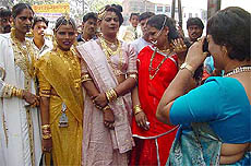 A eunuch takes a photograph of fellow eunuchs