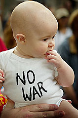 Five-month-old Kitiana McEwan wears a peace message