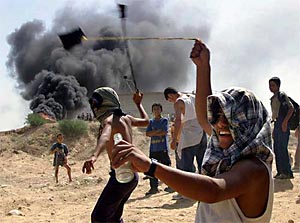 Palestinian boys hurl stones during clashes with Israeli troops