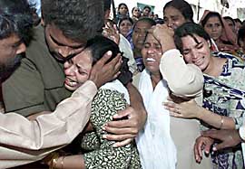 Relatives mourn at the funeral service of Benjamin Talib in Karachi 