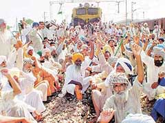 Farmers hold a sit-in on the railway tracks