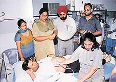 Mrs Lakhwinder Kaur Garcha, OSD to Punjab Chief Minister (second from left), watches a patient