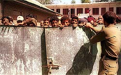 Villagers wait to receive their voter identity cards