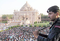A policeman stands guard at the Swaminarayan temple