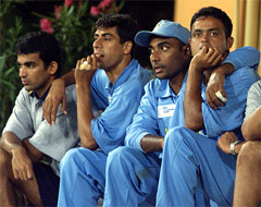 Indian players Zaheer Khan, Ashish Nehra and Dinesh Mongia wait for rain to stop