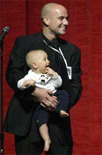 Tennis star Andre Agassi holds his son Jaden