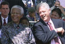 Former South African President Nelson Mandela and former US President Bill Clinton smile