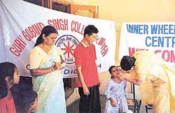 Doctors examine children at a dental camp organised by the NSS unit of Guru Gobind Singh College, Sector 26, at Raipur Kalan village on Wednesday