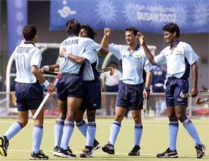 Indian hockey players celebrate their second goal, scored by Dhanaraj Pillay