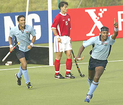 India�s Daljit Singh (R) celebrates after scoring a goal 