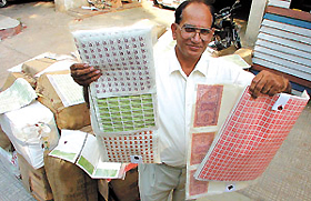 Crime Branch officials display some of the fake revenue and court stamp papers.