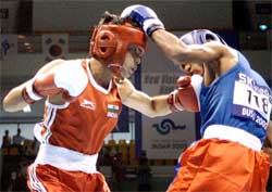 India�s Qamar Md. Ali lands his punch