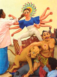 Artists form Kolkata give final touches to the idol of Goddess Durga