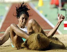 India's Anju Bobby George lands during the women's long jump final
