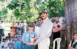 A student receives prize from the Chief Wildlife Warden, Chandigarh, Mr Ishwar Singh, at Leisure Valley on Tuesday.