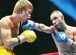 World Boxing Association (WBA) super bantamweight challenger Salim Medjkoune of France lands a punch