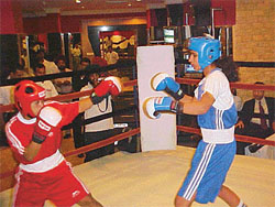 A women�s exhibition boxing match in progress at a Ludhiana hotel
