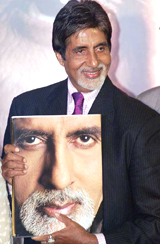 Celluloid screen legend Amitabh Bachchan holds a copy of the book