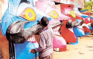 An artist gives finishing touches to an effigy of Ravan.