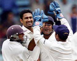 Indian players celebrate after Kumble took the wicket of Ramnaresh Sarwan