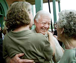 Former President Jimmy Carter hugs friends