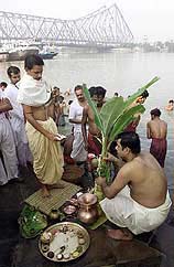 A priest worships with pilgrims