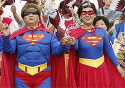 South Korean women wear Super-Man costumes
