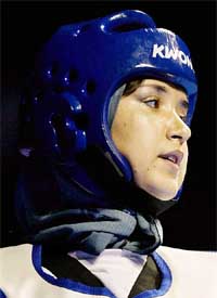 Roia Zamani from Afghanistan, wearing a scarf under the head protector, concentrates during her fight