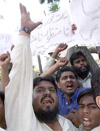 Supporters of Muthahida Majlis-e-Amal, an alliance of six hardline religious parties, chant slogans against alleged rigging in vote counting