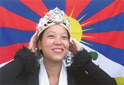 Dolma Tsering of India, winner of the first Miss Tibet pageant, adjusts her crown during a news conference in Dharamsala on Sunday