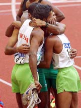 Members of India's 4x400m relay team gather together after finishing second on Sunday