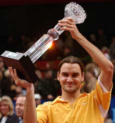 Roger Federer of Switzerland raises his trophy