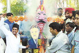 Activists of the Anti-Terrorist Front burning the effigy of Pakistan President Pervez Musharraf on the eve of Dasehra at Jantar Mantar in the Capital on Monday.