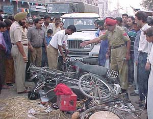The police inspects the mangled remains of vehicles