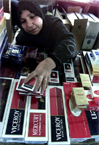 An Iraqi woman sells cigarettes