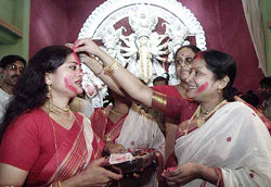 Hindu women smudge vermilion on each other