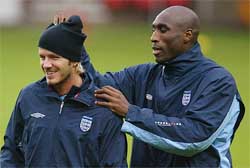 England captain David Beckham has his hat pulled by Sol Campbell 