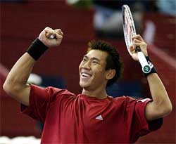 Thailand's Paradom Srichaphan celebrates his victory over Brazilian Gustavo Kuerten