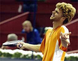 Brazilian Gustavo Kuerten reacts during his losing match