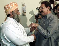 Fazal-ur-Rehman , Secretary-General of Muttahida Majlis-e-Amal, an alliance of six hardline Islamic parties, greets Makhdoom Amin Fahim of the PPP