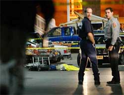 A body lays in the parking lot