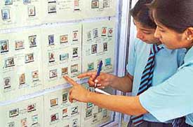 Schoolchildren admire rare stamps at the philatelic exhibition held at Sandesh Bhavan